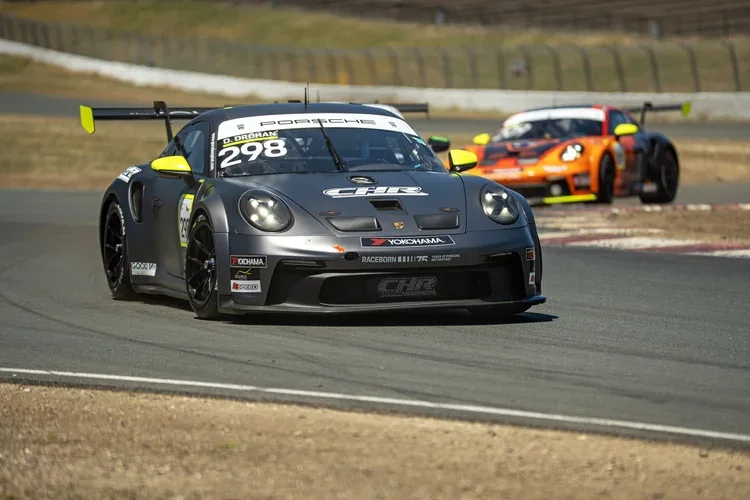 Porsche number 298 leads an orange prototype on a race circuit