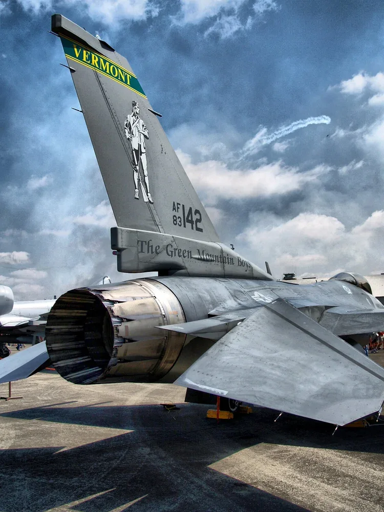 Military jet parked under an open sky