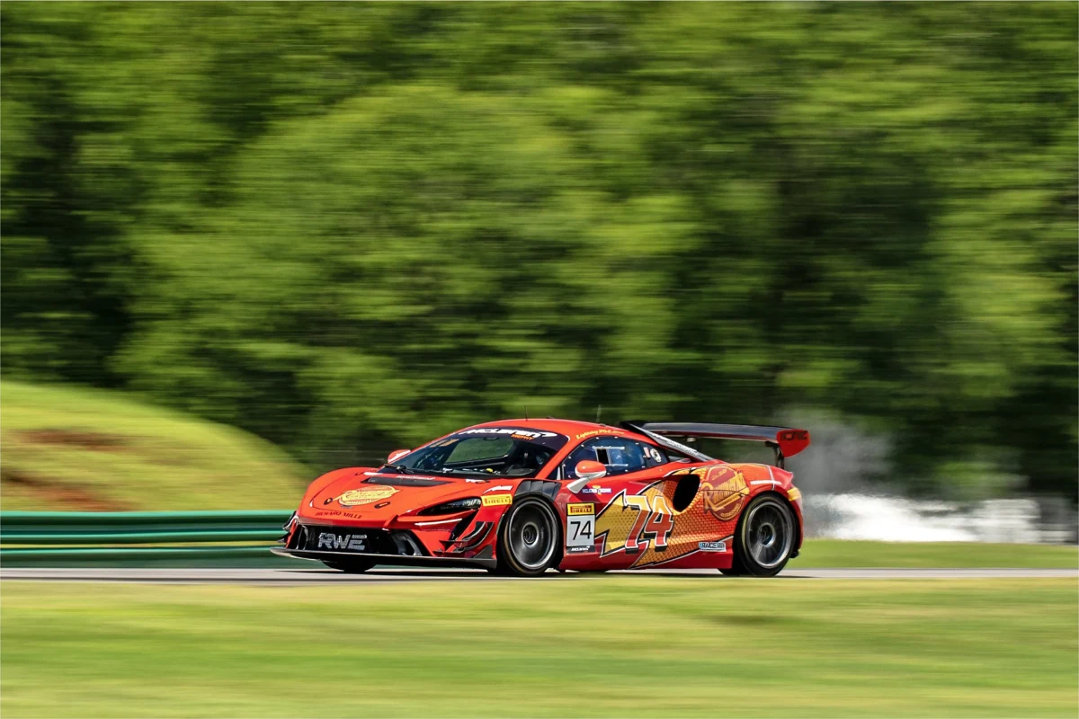 McLaren Trophy race car accelerating against a blurred green backdrop